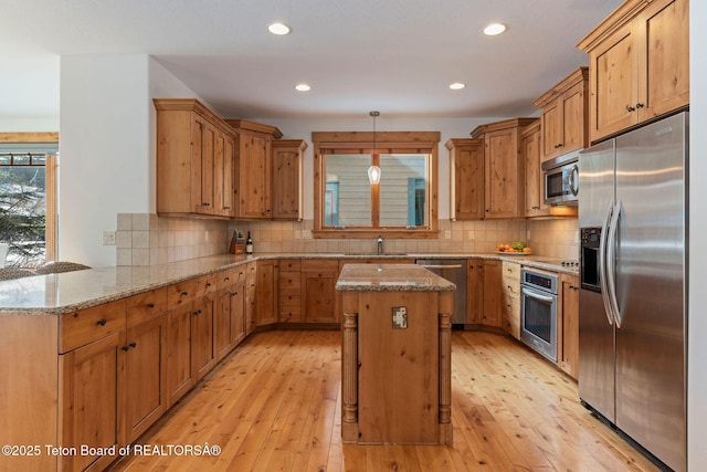 19 Moulton Ln, Victor, ID 83422 - kitchen with appliances with stainless steel finishes, a sink, light stone countertops, light wood-style flooring, and recessed lighting