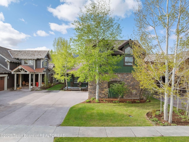 19 Moulton Ln, Victor, ID 83422 - craftsman-style house featuring driveway, a front yard, stone siding, and board and batten siding