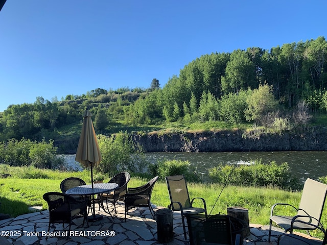 4641 N River Hollow Dr, Ashton, ID 83420 - view of patio featuring a water view and a wooded view