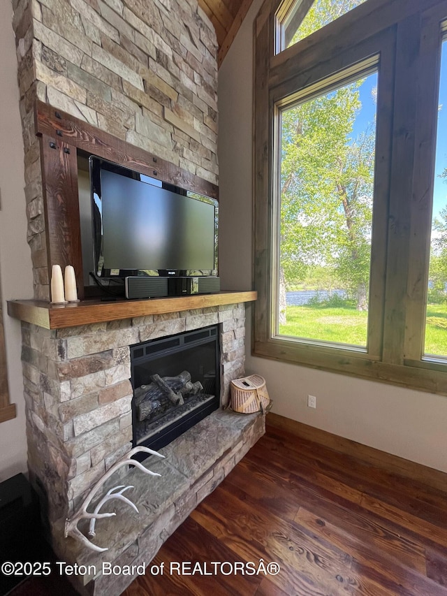 4641 N River Hollow Dr, Ashton, ID 83420 - living area featuring vaulted ceiling, wood finished floors, and a stone fireplace