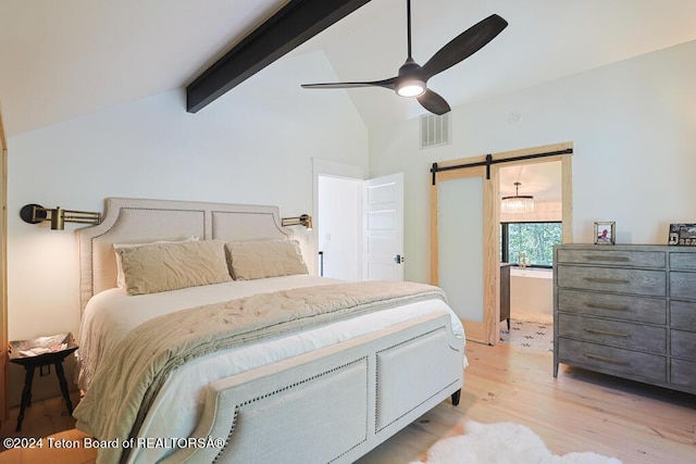 bedroom with light wood-type flooring, a barn door, and ceiling fan