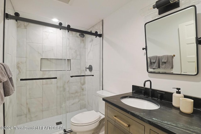 full bathroom with a shower stall, toilet, and vanity
