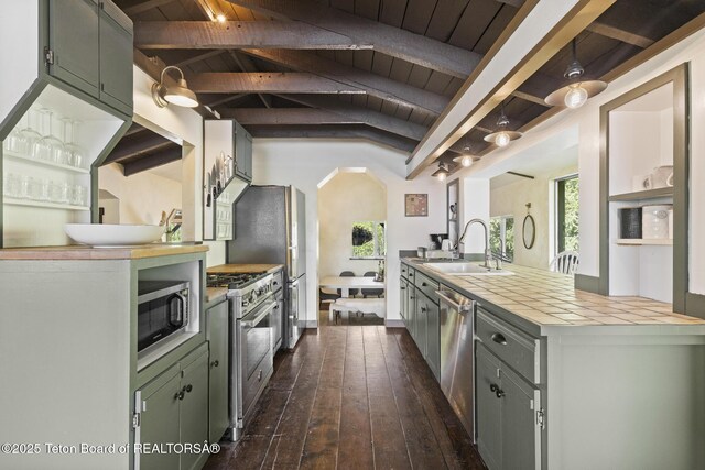 2077 Highland Way, Victor, ID 83455 - kitchen featuring stainless steel appliances, a wood ceiling with exposed beams, dark wood finished floors, light countertops, and green cabinets
