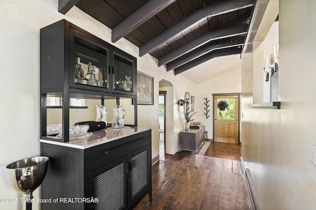 2077 Highland Way, Victor, ID 83455 - kitchen featuring dark cabinetry, dark wood finished floors, arched walkways, glass insert cabinets, and wood ceiling
