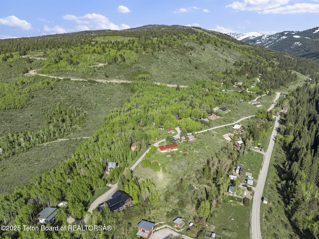 2077 Highland Way, Victor, ID 83455 - aerial overview of property's location featuring a forest and a mountainous background