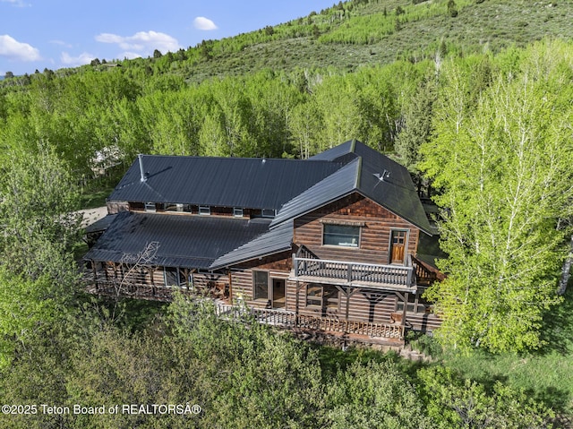 2077 Highland Way, Victor, ID 83455 - rear view of house with a wooded view, a metal roof, and a deck