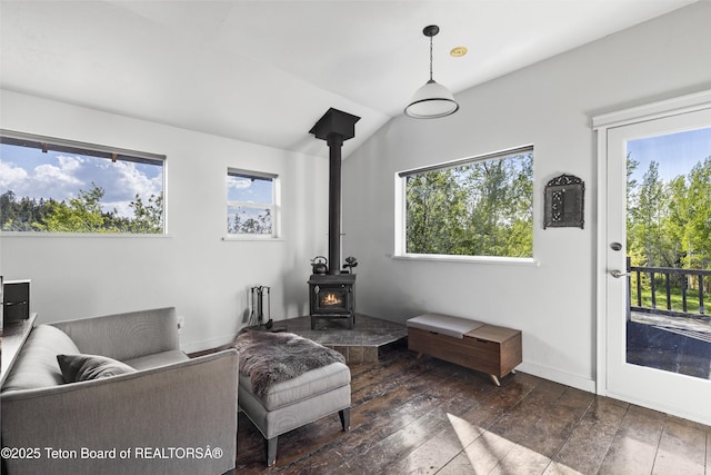 2077 Highland Way, Victor, ID 83455 - living area featuring a wood stove, dark wood-type flooring, and vaulted ceiling