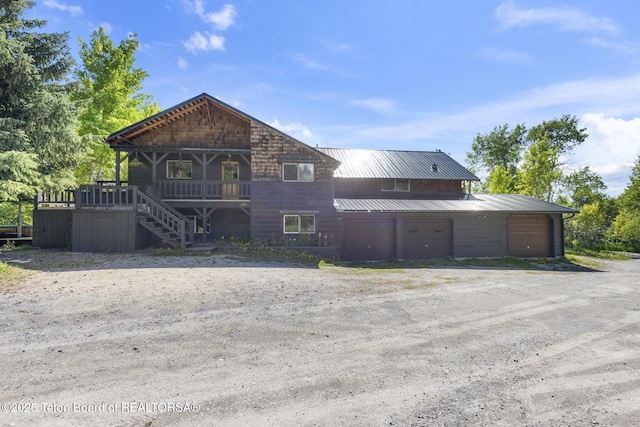 2077 Highland Way, Victor, ID 83455 - rustic home with dirt driveway, a metal roof, and stairway
