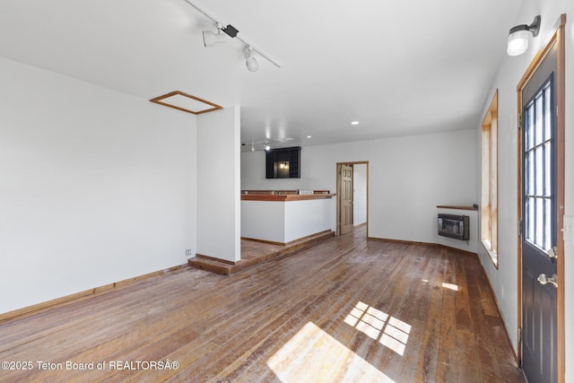 2077 Highland Way, Victor, ID 83455 - unfurnished living room with wood-type flooring, heating unit, rail lighting, and recessed lighting