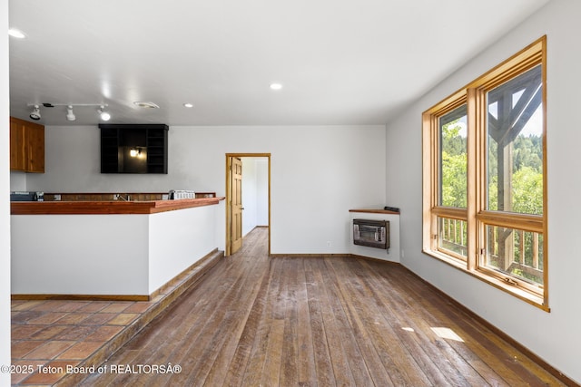 2077 Highland Way, Victor, ID 83455 - unfurnished living room featuring heating unit, hardwood / wood-style floors, and recessed lighting