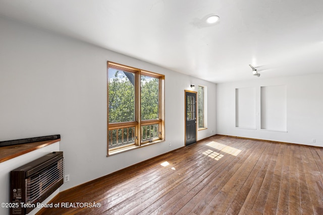 2077 Highland Way, Victor, ID 83455 - unfurnished living room with hardwood / wood-style flooring and heating unit