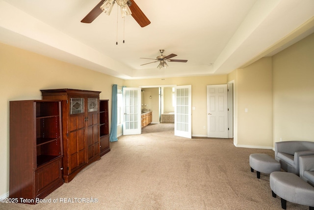 63 Iroquois Trl, Boulder, WY 82923 - sitting room featuring french doors, light carpet, ceiling fan, a raised ceiling, and baseboards