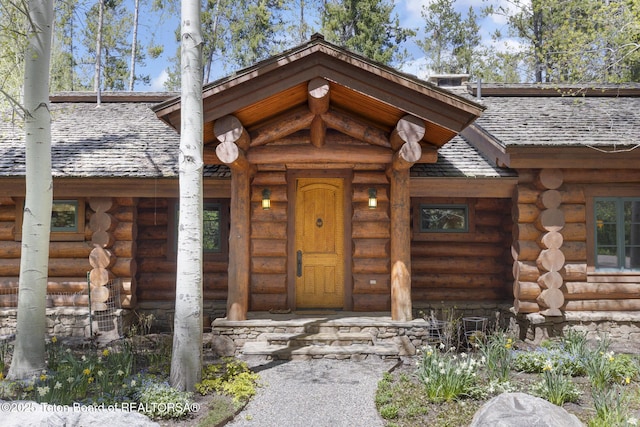 5725 W Caddis Fly Dr, Wilson, WY 83014 - doorway to property featuring log exterior and covered porch
