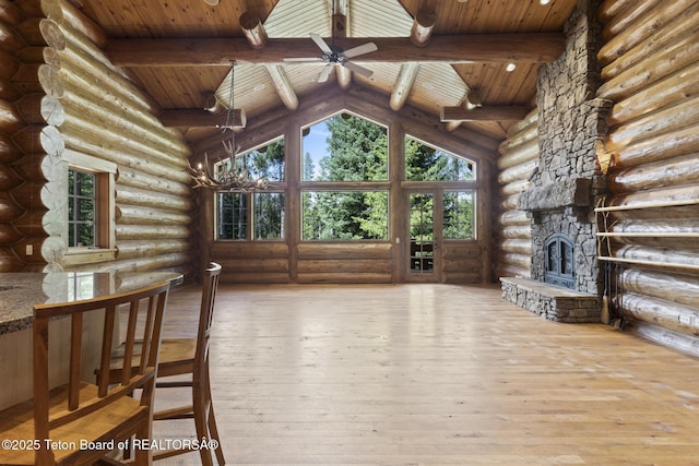 5725 W Caddis Fly Dr, Wilson, WY 83014 - unfurnished living room featuring a wood ceiling with exposed beams, rustic walls, hardwood / wood-style flooring, ceiling fan, and high vaulted ceiling
