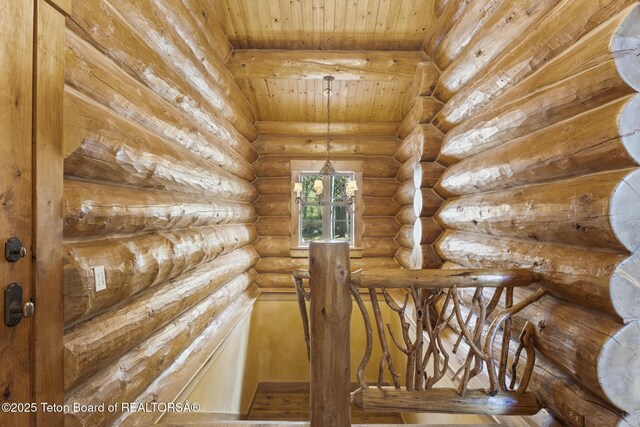 5725 W Caddis Fly Dr, Wilson, WY 83014 - staircase featuring wooden ceiling and log walls