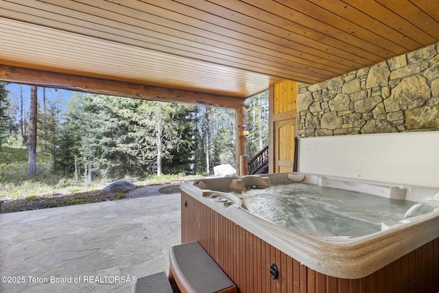 5725 W Caddis Fly Dr, Wilson, WY 83014 - view of patio featuring a hot tub and view of wooded area