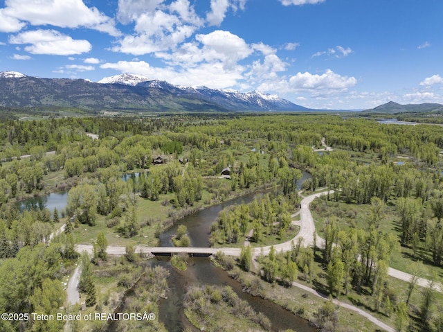 5725 W Caddis Fly Dr, Wilson, WY 83014 - aerial view of property and surrounding area featuring a heavily wooded area and a water and mountain view