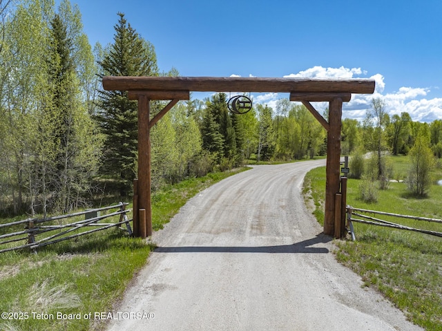 5725 W Caddis Fly Dr, Wilson, WY 83014 - view of dirt / gravel driveway featuring a forest view