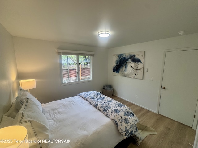 385 N Glenwood St, Jackson, WY 83001 - bedroom with wood finished floors and baseboards
