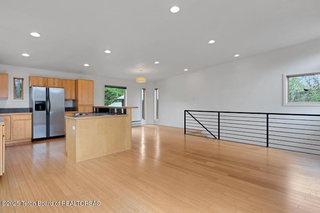 668 S Millward St, Jackson, WY 83001 - kitchen with stainless steel refrigerator with ice dispenser, recessed lighting, a kitchen island, light wood finished floors, and open floor plan