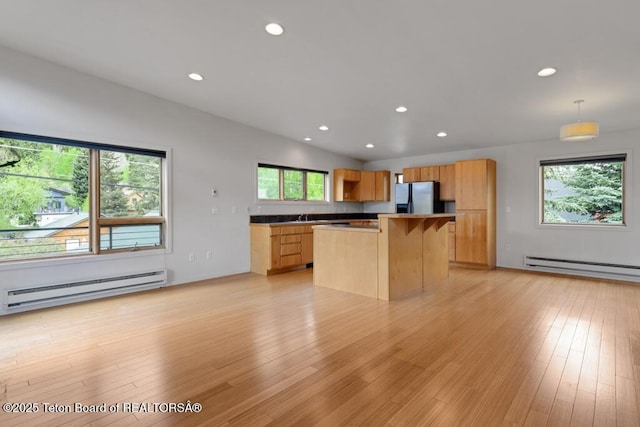 668 S Millward St, Jackson, WY 83001 - kitchen featuring refrigerator with ice dispenser, a baseboard heating unit, recessed lighting, a center island, and plenty of natural light