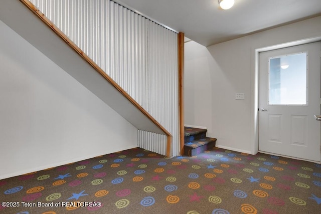 668 S Millward St, Jackson, WY 83001 - entrance foyer featuring baseboards, carpet, and stairway