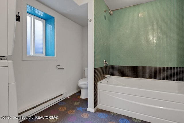 668 S Millward St, Jackson, WY 83001 - bathroom with a baseboard heating unit, toilet, estacked washer and dryer, and baseboards