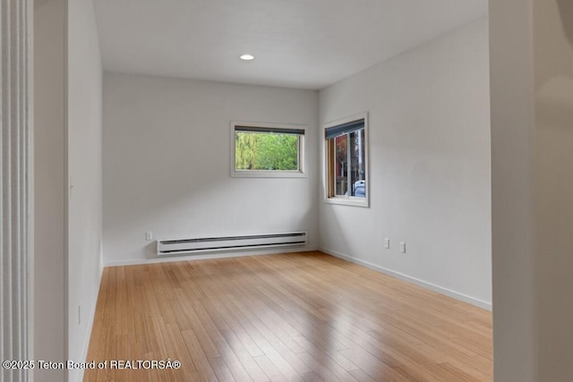 668 S Millward St, Jackson, WY 83001 - unfurnished room with baseboard heating, wood finished floors, baseboards, and recessed lighting