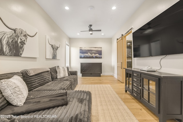 2399 Chapel Rd, Swan Valley, ID 83449 - living area with a barn door, a ceiling fan, light wood-style floors, recessed lighting, and baseboards