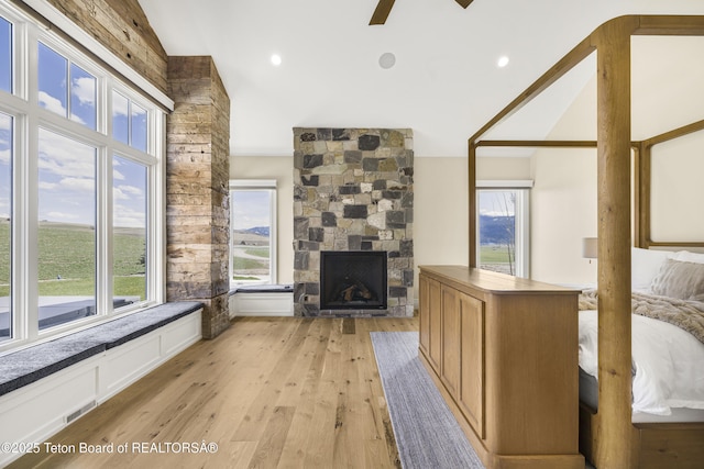2399 Chapel Rd, Swan Valley, ID 83449 - living room with plenty of natural light, a stone fireplace, a ceiling fan, light wood-style flooring, and lofted ceiling