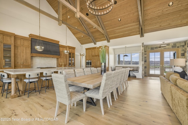 2399 Chapel Rd, Swan Valley, ID 83449 - dining room with high vaulted ceiling, wooden ceiling with exposed beams, light wood-type flooring, and french doors