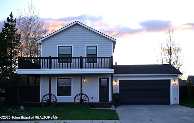 418 Par Ave, Pinedale, WY 82941 - view of front of house featuring a balcony, concrete driveway, and an attached garage