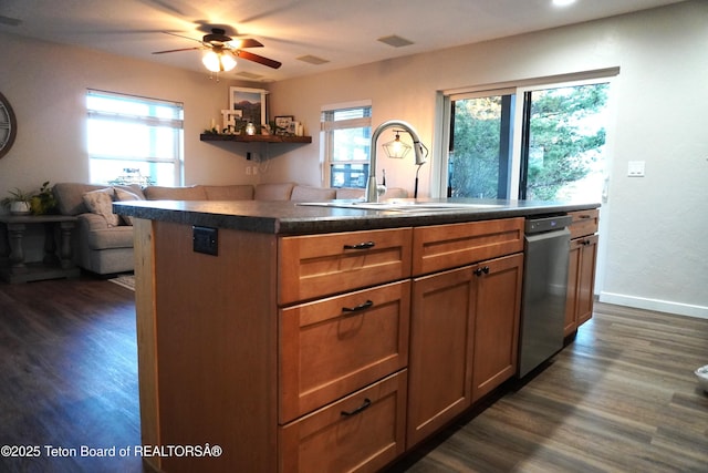 418 Par Ave, Pinedale, WY 82941 - kitchen featuring stainless steel dishwasher, a sink, healthy amount of natural light, and dark wood-style flooring