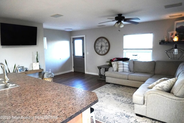 418 Par Ave, Pinedale, WY 82941 - living area with dark wood-type flooring, a ceiling fan, and baseboards