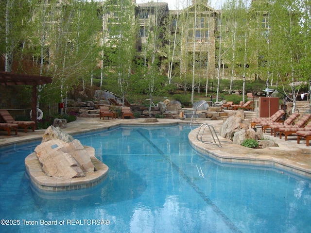 7680 Granite Loop Rd Unit 655, Teton Village, WY 83025 - community pool with a patio area and a pergola