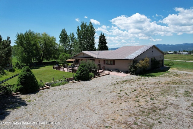 216 County Road 179s, Thayne, WY 83127 - rear view of property featuring a patio area, a yard, and metal roof