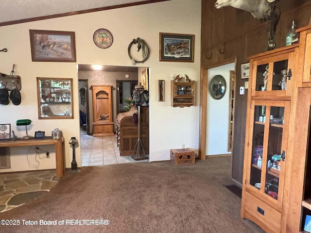 216 County Road 179s, Thayne, WY 83127 - interior space featuring light carpet, vaulted ceiling, light tile patterned floors, and a textured ceiling