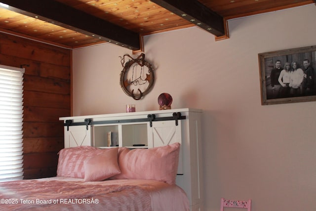 588 S Oak St, Labarge, WY 83123 - bedroom featuring wooden ceiling with exposed beams and a barn door