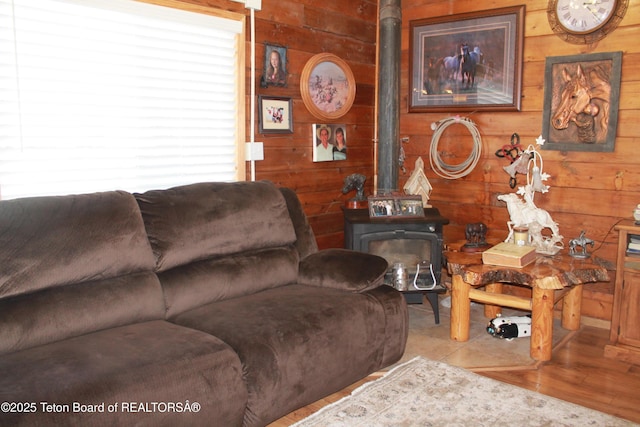 588 S Oak St, Labarge, WY 83123 - living room featuring a wood stove and wood walls