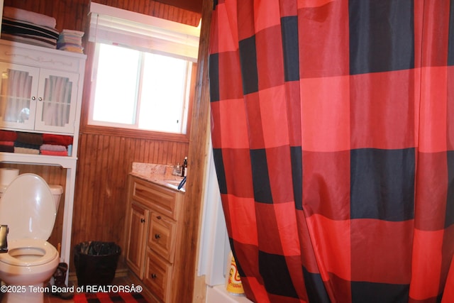 588 S Oak St, Labarge, WY 83123 - full bath featuring curtained shower, wooden walls, and toilet