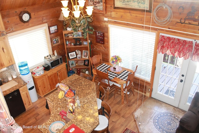 588 S Oak St, Labarge, WY 83123 - dining area with a chandelier, plenty of natural light, wood walls, and light wood-style flooring