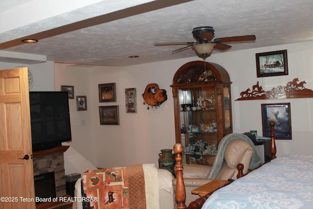 588 S Oak St, Labarge, WY 83123 - bedroom with a textured ceiling and a fireplace