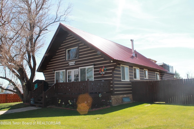588 S Oak St, Labarge, WY 83123 - view of home's exterior with a wooden deck, metal roof, french doors, and log siding