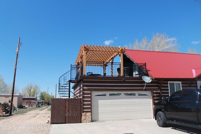 588 S Oak St, Labarge, WY 83123 - cabin with log siding, metal roof, driveway, stairs, and a garage