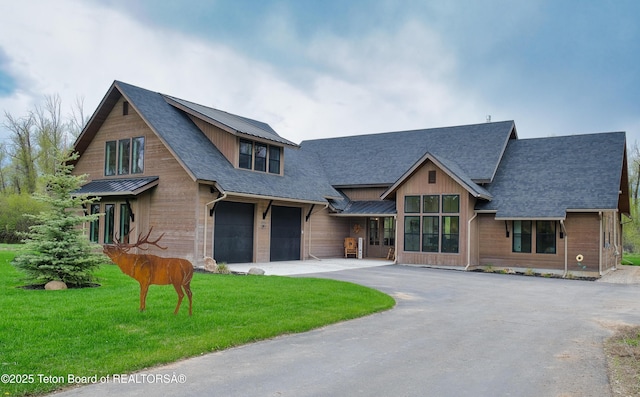 358 Solitude Ln, Tetonia, ID 83452 - view of front of home featuring asphalt driveway, roof with shingles, a garage, a standing seam roof, and metal roof