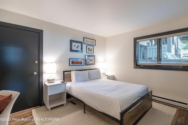3600 W Michael Dr Unit B-2-1, Teton Village, WY 83025 - bedroom featuring a baseboard radiator and light wood finished floors