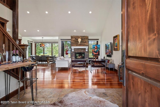 62 Hastings Dr, Victor, ID 83455 - living room with a stone fireplace, recessed lighting, stone finish floors, and lofted ceiling