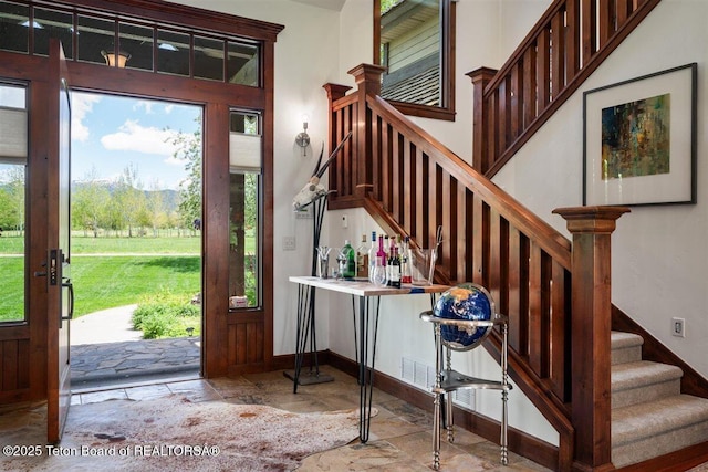 62 Hastings Dr, Victor, ID 83455 - foyer entrance featuring stone tile flooring, stairs, healthy amount of natural light, and baseboards
