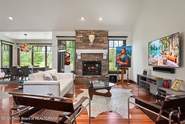 62 Hastings Dr, Victor, ID 83455 - living area featuring wood finished floors, a stone fireplace, recessed lighting, and baseboards