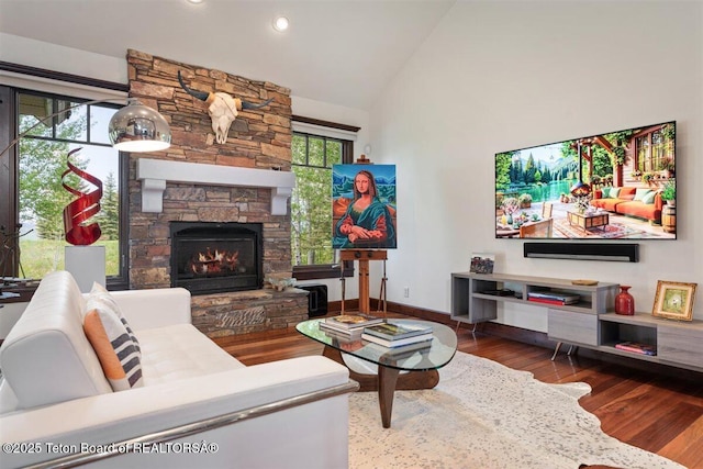 62 Hastings Dr, Victor, ID 83455 - living room with wood finished floors, a fireplace, high vaulted ceiling, baseboards, and recessed lighting